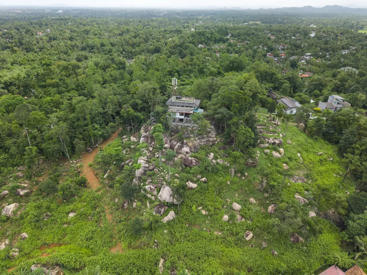Aerial view of Sivora Hills surrounded by greenery and natural rock formations